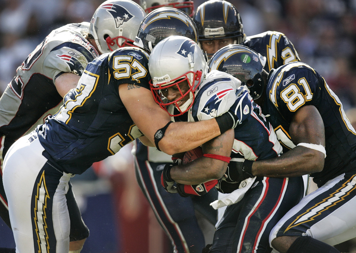 Patriots cornerback Ellis Hobbs is tackled after an interception against the San Diego Chargers